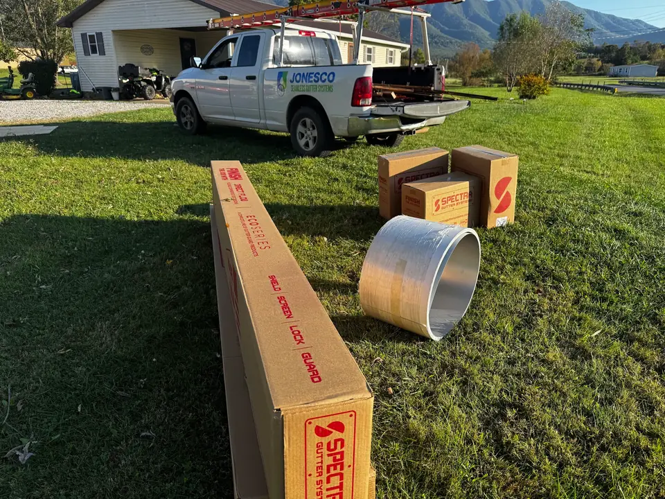 Gutter coil and downspout stock staged beside a JonesCo truck